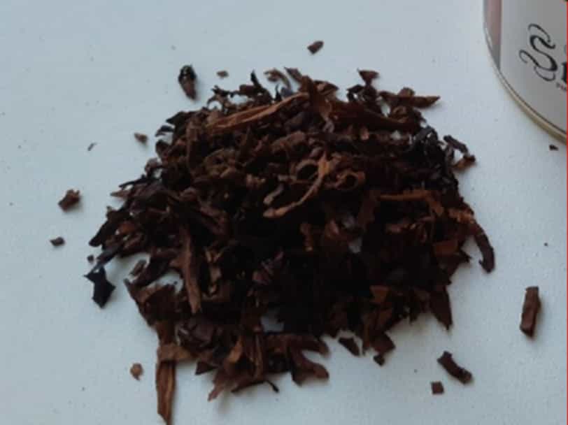 Close-up of tobacco leaves being mixed