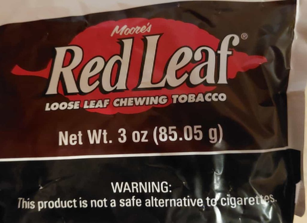 Red tobacco leaf-themed label on a tobacco product